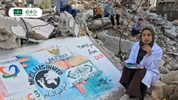 Seniman Palestina Lukis Logo LAZISNU di Puing Bangunan, Wujud Terima Kasih